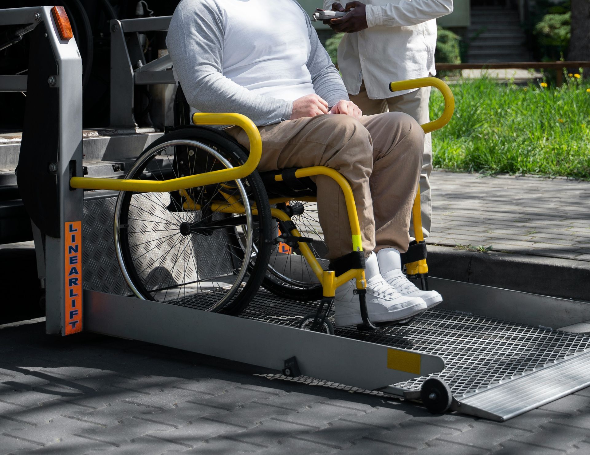 A man sitting in a wheelchair next to a van